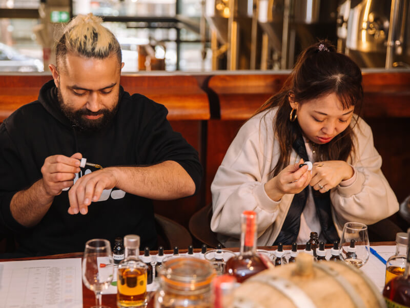 A man and woman making perfume together.